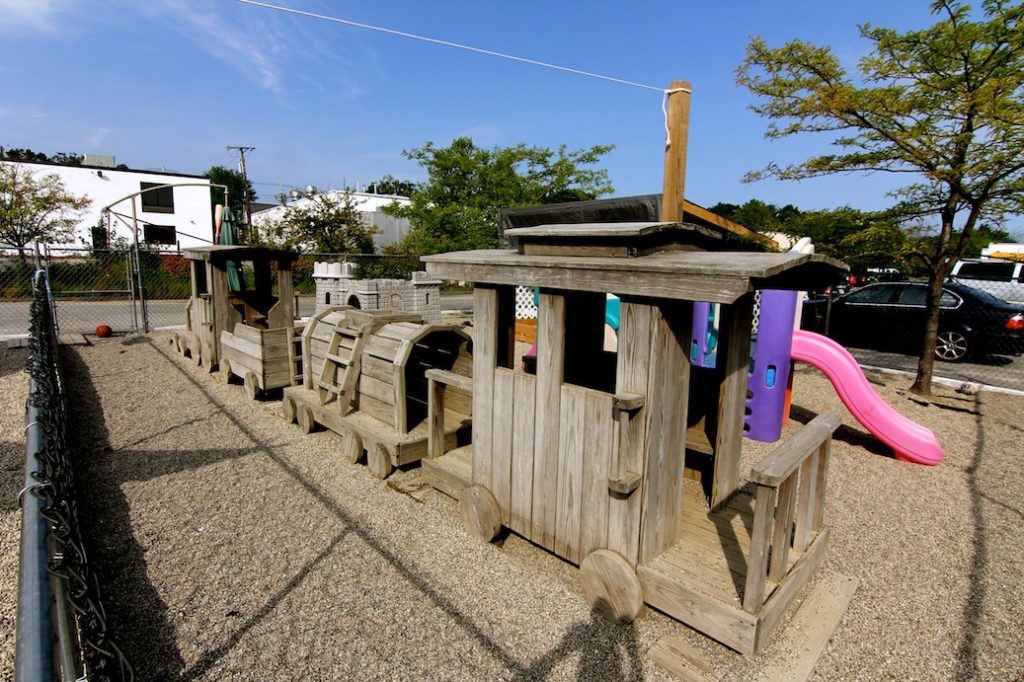 Burlington TLC Train playground, wooden train car in rock playground