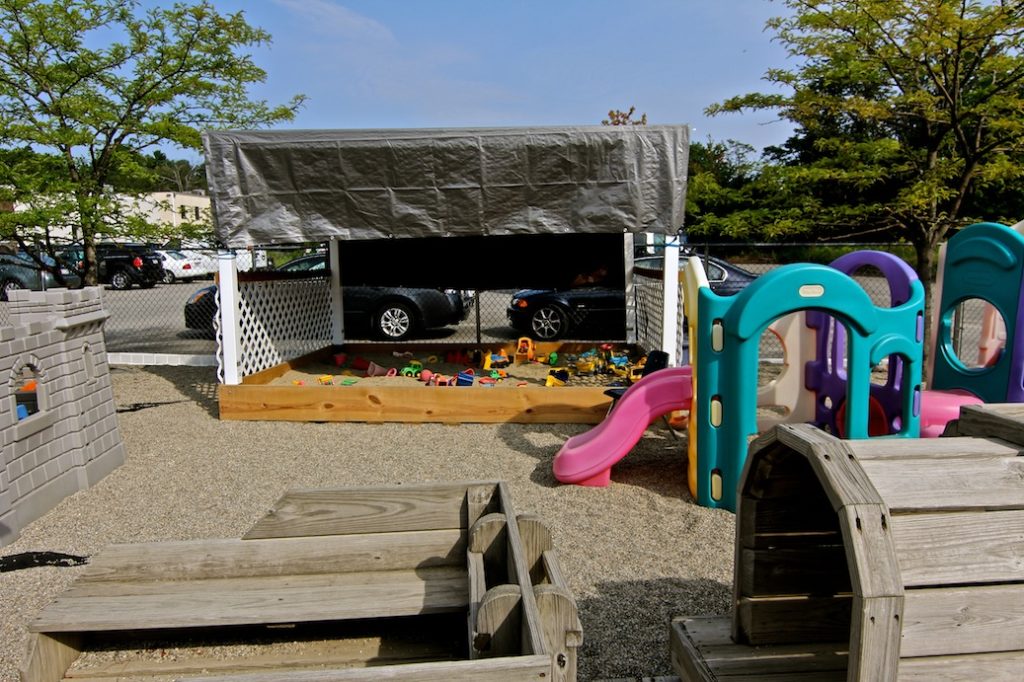 Burlington TLC sandbox in rock playground with wooden train and other structures