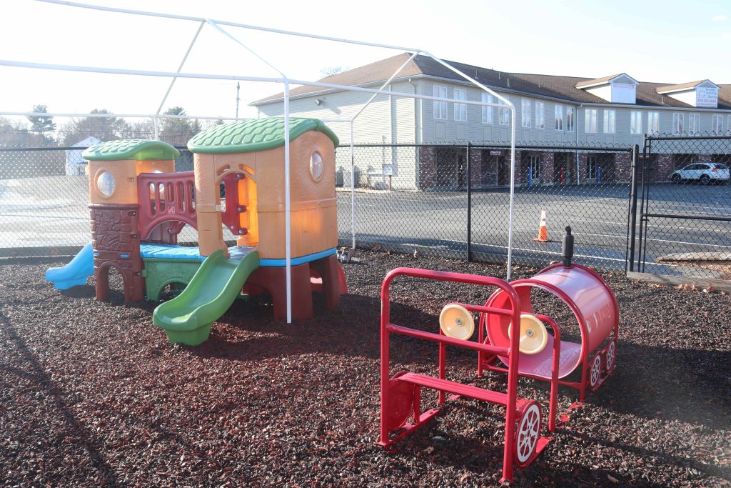 Wilmington TLC toddler playground with structures on rubber mulch