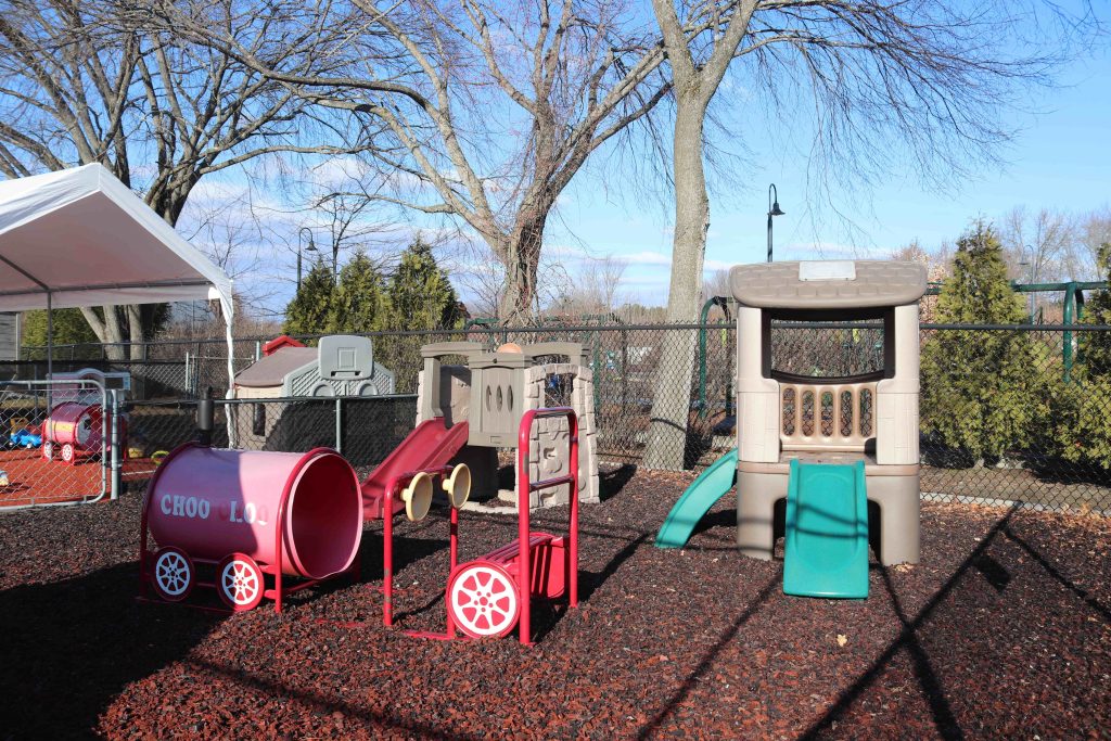 Wilmington TLC toddler playground with structures on rubber mulch